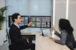 © reewungjunerr - Business professionals analyzing data and discussing financial reports with digital dashboards and graphs in a modern office setting, focusing on strategy and performance.