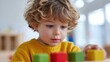 © KASUEMA SALAE - A child playing with interactive toys in a bright, cheerful classroom filled with natural light