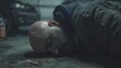 © Unique Image - Dramatic close-up of a bald bearded man lying unconscious on a wet concrete floor.