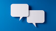© peterschreiber.media - White speech bubbles resting on a blue colored background with copy space - 3D illustration