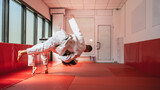 Two judo athletes performing a dramatic throw in training session