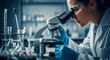 © rifqi - Focused Scientist Examining Sample Under Microscope in Laboratory, Blue Gloves, Safety Glasses.