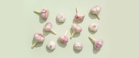 Wall Mural - Many fresh garlic on green background, top view