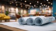© Bluenana - Rolled blueprints on a table in a modern interior