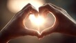 © ปฏิภาน ผดุงรัตน์ - Two hands forming a heart shape in front of the sun. The sunlight shines brightly through the heart, symbolizing love and warmth