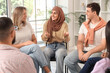© Pixel-Shot - Young Muslim woman talking at group therapy session