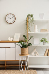 Poster - interior of light room with wall clock, commode and shelf unit