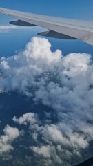 Wall Mural - Vertical View, Flying Above Honolulu Hawaii USA, Airplane Passenger POV of Clouds, Coastline and Ocean