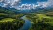 © Lilyterompet - Panoramic view of a winding river valley, lush green meadows, and mountains