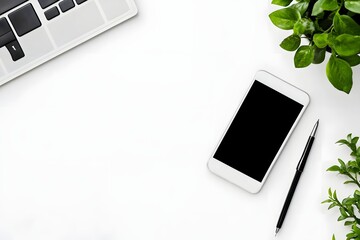 top view of minimalist white desk with smartphone, pen, and single green plant 
