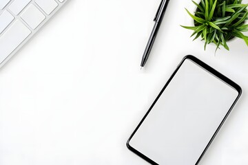 top view of minimalist white desk with smartphone, pen, and single green plant 
