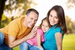 © BillionPhotos.com - Young happy family with child hug outdoor