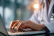 © adit - Close-up of doctor's hands typing on laptop (2)