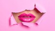 © Jagad - Close-up view of glamorous, pink lips peeking through a ripped paper background, evoking a playful and captivating aesthetic.