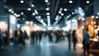 © Daniel - Blur, defocused background of public exhibition hall Business tradeshow, job fir, or stock market. Organzation or company event, cmmercial trading, or shoppng mall marketing advertisment concept