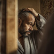 © Maria - Bearded man wearing bathrobe touching his hair while suffering from anxiety, depression, loneliness and mental health issues in the bathroom
