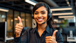 © Kinza - Smiling woman with headset gives thumbs up from modern office, representing excellent customer service and positive work environment.
