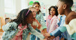 © peopleimages.com - Education, huddle and motivation with children in class of elementary school for success or support. Hand stack, learning and study with group of kids in classroom for achievement as friends