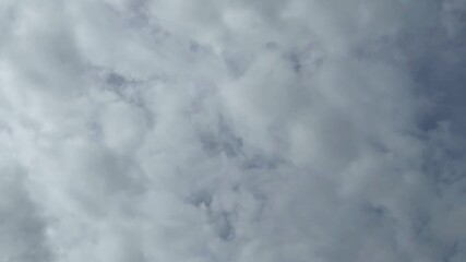 Wall Mural - Timelapse video of cumulus clouds gathering for bad weather under the influence of wind. Natural blue sky background. Autumn cloudscape. Weather forecast