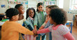 © peopleimages.com - Stack of hands, celebration and kids in classroom for support, learning or education. Motivation, teamwork and group of students with growth, friendship or childhood development at elementary school.