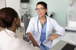 © fizkes - Elderly therapist shaking hands with young African woman patient