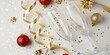 © Pablo Kluba - Two empty champagne flutes on white surface with golden ornaments, ribbons and star shaped confetti for festive holiday celebration and seasonal design purposes