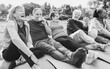 Senior people having fun drinking hot tea after yoga lesson at city park - Joyful elderly lifestyle and sport concept - Focus on left latin woman face - Black and white editing