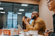 © Johnér - Focused bald male entrepreneur listening to ideas shared in meeting at office