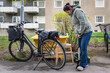 © Johnér - Full length of woman pumping air in cycle tire