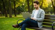 © Tubagus - Man working on laptop in park