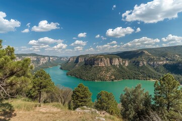 Wall Mural - view across the emerald lake towards towering canyon peaks in a lush natural setting