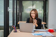 © maeching - Happy and excited young Asian woman after discussing successful project at work and working concept at office.