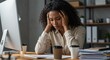 © Sandor - frustrated office worker at desk with paperwork and computer feeling stressed during work hours