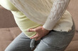 © sosiukin - Pregnant woman with painful belly on sofa at home