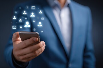 Businessman holds phone, digital icons of people and messages appear around it