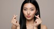 © thoif - Asian woman making Korean heart sign, love gesture, beauty concept