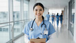 © jack - Portrait of Young Smiling Female Nurse: Professional Healthcare Worker in Modern Hospital Hallway, Depicting Care and Confidence