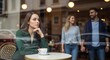 © Octopus16 - A woman sits alone in a cafe, watching a happy couple walk by through window reflection.