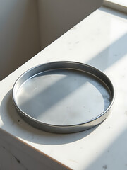 Wall Mural - grey metal tray lies atop worn concrete surface partially reflected soft light nearby window white marble texture