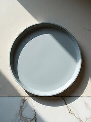 Wall Mural - grey metal tray lies atop worn concrete surface partially reflected soft light nearby window white marble texture