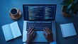 © Somkid - A person types on a laptop displaying code, surrounded by a coffee cup, notebook, and plant, creating a productive workspace atmosphere.