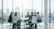 © David Zarzosa - Blurred business meeting in modern office with professionals seated and discussing around conference table with city view.