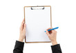 © Muhammad - Focused professional writing notes on blank clipboard, capturing ideas and planning projects with precision