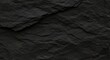 © Farhan - Striking textural black slate surface evoking raw earth and geological formations