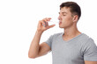 © Prostock-studio - Handsome calm muscular young caucasian guy drinking water from glass, isolated on white background, panorama, copy space. Health care during covid-19 pandemic, aqua balance and hydration, studio shot