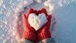 © Dream Studio - A person holding a heartshaped snowball in red gloves on a snowy winter day, symbolizing love and warmth during the cold season