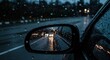 © Hungarian - A close-up view of a car's side mirror reflecting a rainy night scene, showcasing the raindrops clinging to the glass and the soft, diffused lights of the street.