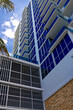 Modern high-rise residential building with glass balconies and blue windows, Miami, Florida