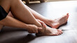 © Jonh_Walker - Asian woman’s hand holding ankle in pain symbolizing injury, sprain, or joint discomfort