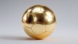 © apa - Golden soccer ball, polished, on a plain backdrop